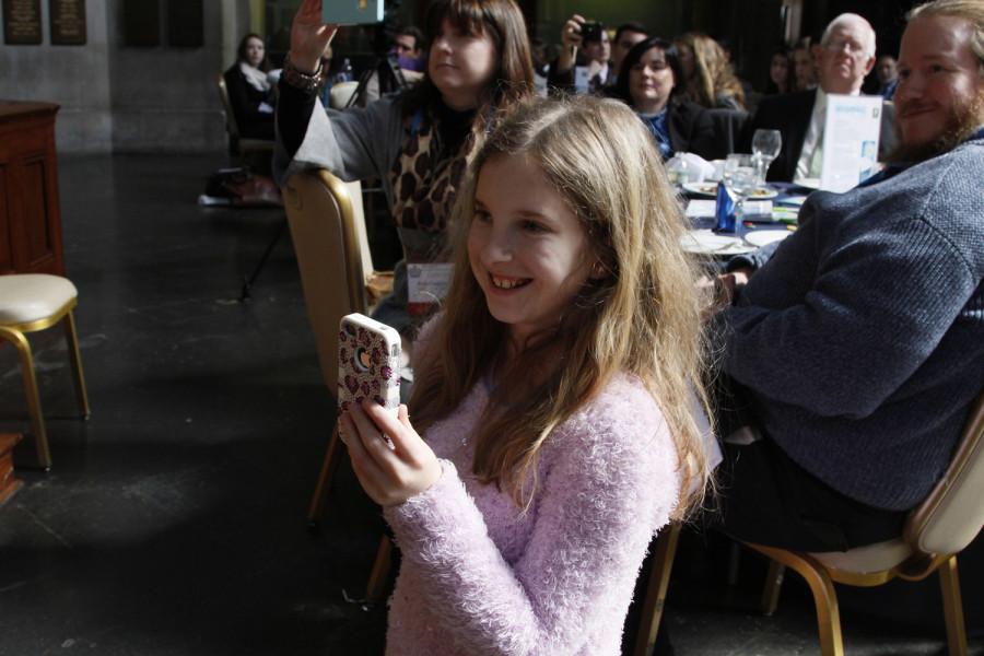 Meredith Cummings ' daughter captures her mother's speech as she receives the 2014 James F. Paschal Award from CSPAA. She received her award at the 2014 CSPA spring convention advisers' awards luncheon on March 21, 2014 at Columbia University's Low Rotunda.